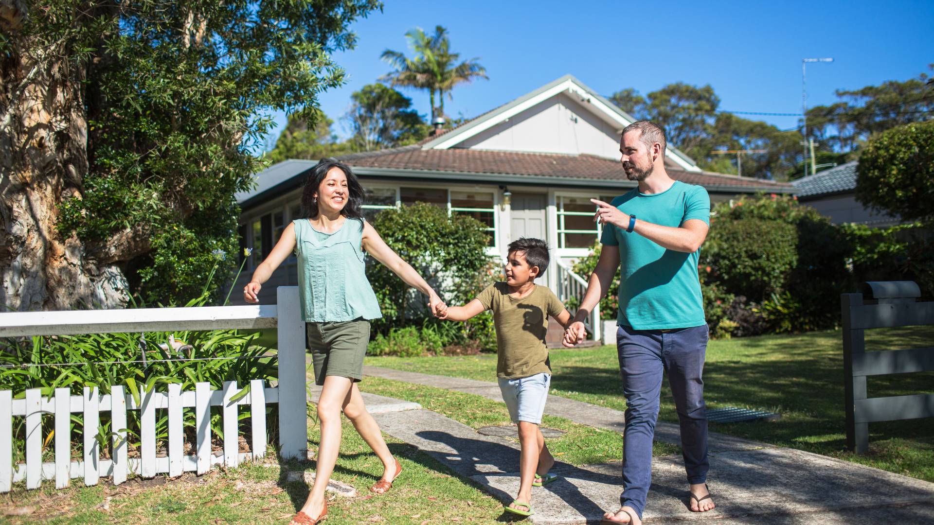 family walking on the front of their house enjoying flea treatment outside house